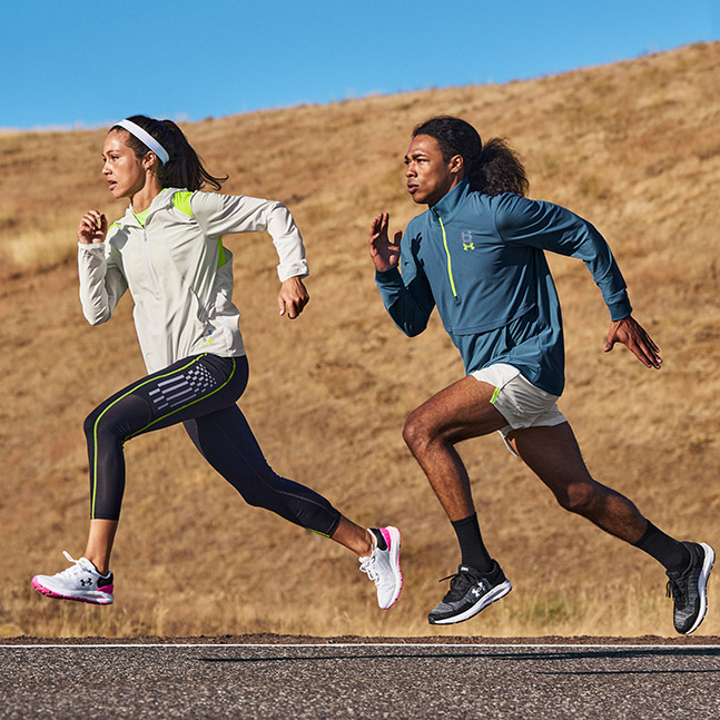Woman and man running in Under Armour running apparel and shoes